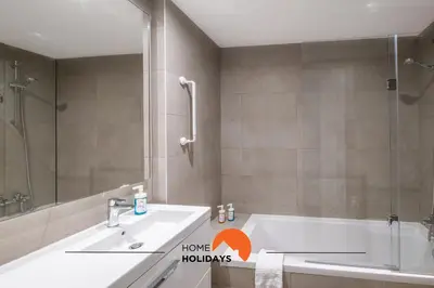 a bathroom with a tub and a shower and a sink at #090 Correeira by Home Holidays in Albufeira