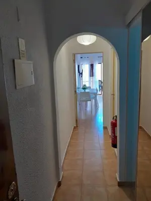 a hallway with an arch leading to a dining room at Apartamento Maria do Céu Villa Magna in Albufeira