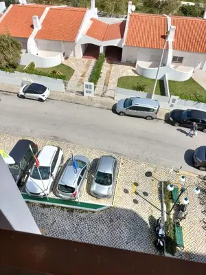 a group of cars parked in a parking lot at Apartamento Maria do Céu Villa Magna in Albufeira