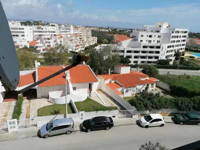 a group of cars parked in a parking lot at Apartamento Maria do Céu Villa Magna in Albufeira