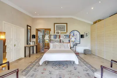 a bedroom with an orange bed and a desk at Villa Oasis by CadenzaLux in Almancil