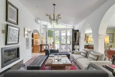 a living room with a blue couch and a table at Villa Oasis by CadenzaLux in Almancil