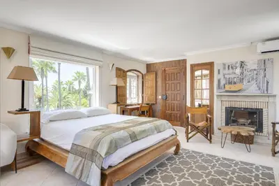a bedroom with a bed and a view of a pool at Villa Oasis by CadenzaLux in Almancil