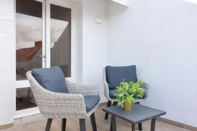 two chairs and a table in a room at CATCH - Vilamoura in Vilamoura