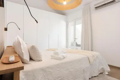 a white bedroom with a bed with towels on it at CATCH - Vilamoura in Vilamoura