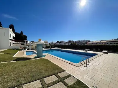 a swimming pool in the backyard of a house at Relaxing 2 Bedroom House 5 minutes away from Vilamoura Marina in Quarteira