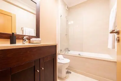 a bathroom with a toilet and a tub and a sink at Vilamoura Hideaway - Golf, Pool & Beach in Vilamoura