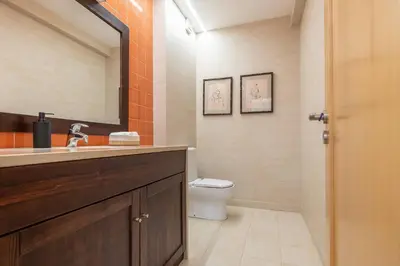 a bathroom with a sink and a toilet and a mirror at Vilamoura Hideaway - Golf, Pool & Beach in Vilamoura