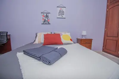 a bedroom with a bed with towels on it at Charming Private Rooms in an Apartment A2 Penha - Faro in Faro