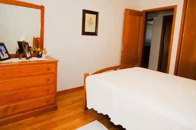 a bedroom with a bed and a dresser and a mirror at Apartamento T2 em condomínio fechado. in Albufeira
