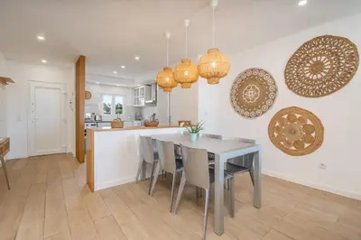 a kitchen and dining room with a table and chairs at Beco do Sol, Albufeira in Albufeira