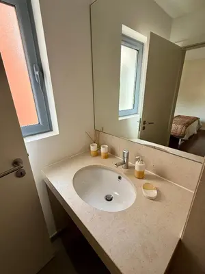 a kitchen with white cabinets and a sink at Victoria Gardens Luxury Apartment by PA Hotels in Quarteira