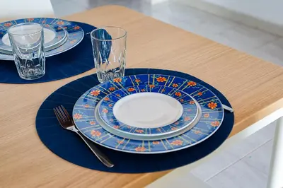 two plates and glasses sitting on a table at Mouramar One bedroom apartment, with pool in Quarteira