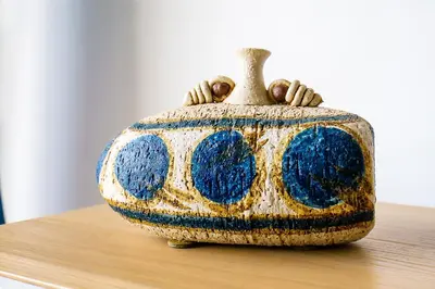 a vase sitting on top of a table at Mouramar One bedroom apartment, with pool in Quarteira