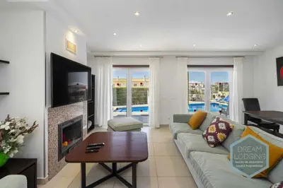 a living room with a couch and a fireplace at Villa Rafaella 3 - Dream Lodging in Albufeira