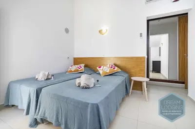 a bedroom with two beds with blue sheets and a mirror at Villa Rafaella 3 - Dream Lodging in Albufeira