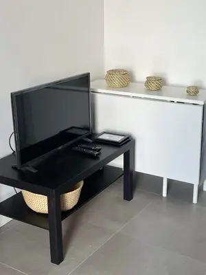 a black desk with a television on top of it at CASA DAS MOURAS in Faro