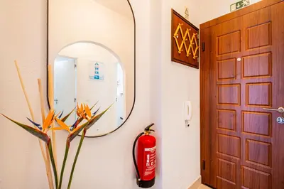 a fire extinguisher next to a door with a fire hydrant at Perfect location NEW holiday apartment in Albufeira