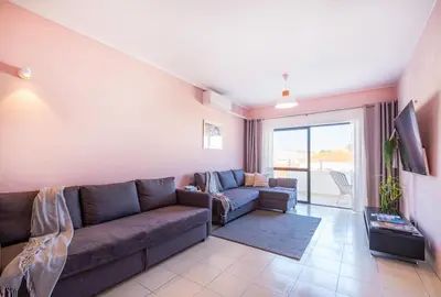 a living room with a couch and a tv at Perfect location NEW holiday apartment in Albufeira