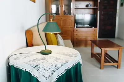 a lamp sitting on a table in a living room at Shiny Central Flat - Pool in Albufeira