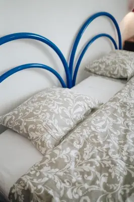 a white bed with two pillows on it at Shiny Central Flat - Pool in Albufeira