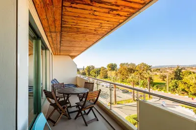 a balcony with a table and chairs and a view at Marina Vilamoura Aquamar 304 By Vilamoura Sun in Vilamoura