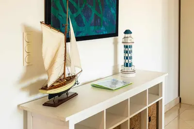 a model boat on a table next to a lighthouse at Marina Vilamoura Aquamar 304 By Vilamoura Sun in Vilamoura