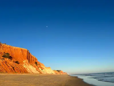 a view of a beach with a cliff at Golden Blue Beach Falésia Apartment in Albufeira