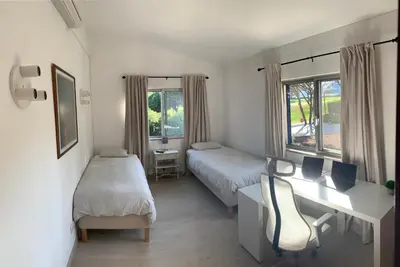 a living room with two couches and a fireplace at Royal Course Villa, Vale do Lobo in Vale do Lobo