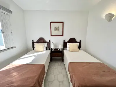 two beds sitting next to each other in a room at Vila Santo Antonio - Vilamoura by HD PROPERTIES in Vilamoura