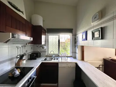 a small kitchen with a sink and a window at Vila Santo Antonio - Vilamoura by HD PROPERTIES in Vilamoura