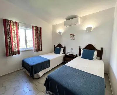 a room with two beds and a window at Vila Santo Antonio - Vilamoura by HD PROPERTIES in Vilamoura
