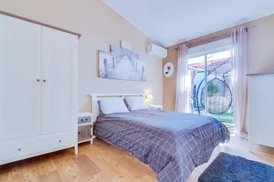 a bedroom with a bed and a large window at Villa Rimbaud in Albufeira