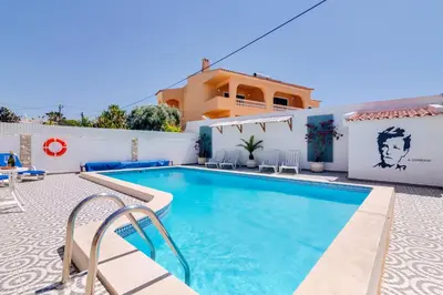 a villa with a swimming pool and a house at Villa Rimbaud in Albufeira