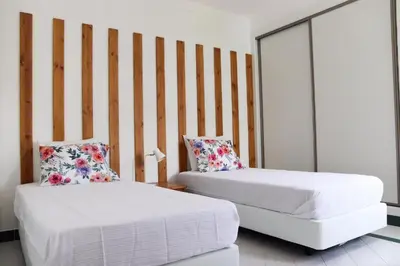 a room with two beds and a couch in it at Apartamento Salgados Mar in Albufeira