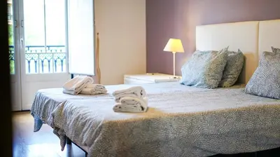 a bedroom with a bed with towels on it at Oura Sunrise 3F Apartment by Stay ici Algarve Holiday Rental in Albufeira