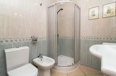a bathroom with a shower and a toilet and a sink at Oura Sunrise 3F Apartment by Stay ici Algarve Holiday Rental in Albufeira
