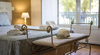 a room with a bed with a hat on it at Oura Sunrise 3F Apartment by Stay ici Algarve Holiday Rental in Albufeira