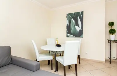 a dining room with a white table and chairs at Oura Sunrise 3F Apartment by Stay ici Algarve Holiday Rental in Albufeira
