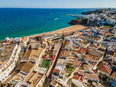 an aerial view of a town with a beach at Vila Origens Boutique Hotel Albufeira – Adults Only in Albufeira