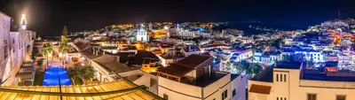 a view of a city at night at Vila Origens Boutique Hotel Albufeira – Adults Only in Albufeira