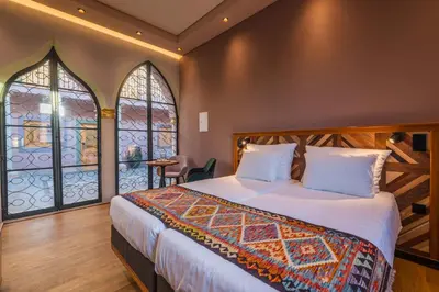 a bedroom with a large bed and a window at Vila Origens Boutique Hotel Albufeira – Adults Only in Albufeira