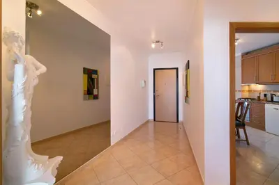 a living room with a statue of a woman on the wall at Quarteira Beach iii in Quarteira