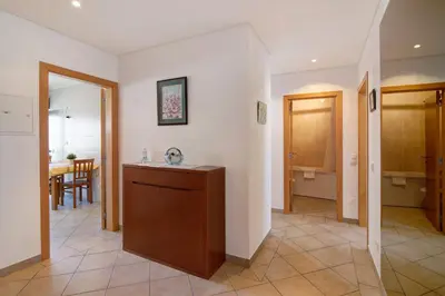 a living room with a kitchen and a dining room at Quarteira Beach I in Quarteira