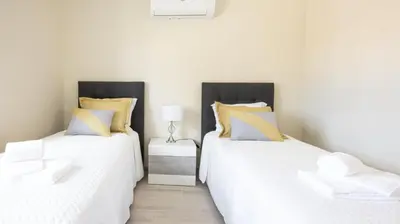 two beds sitting next to each other in a bedroom at Villa O Sonho do Algarve - Private Swimming Pool - BY BEDZY in Albufeira