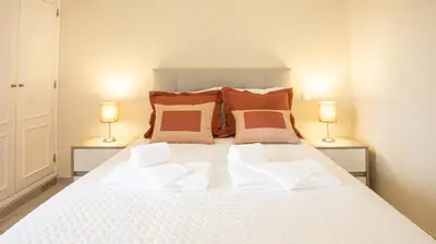 a large white bed with two lamps on either side of it at Villa O Sonho do Algarve - Private Swimming Pool - BY BEDZY in Albufeira