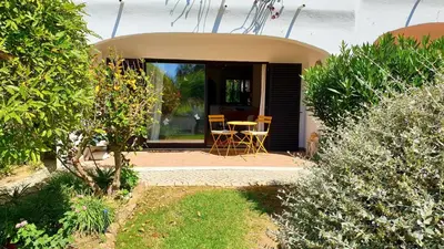 a house with a patio with a table and chairs at Apartment São Rafael 63 - Beach - Pool - Free wi-fi - Air Con in Albufeira