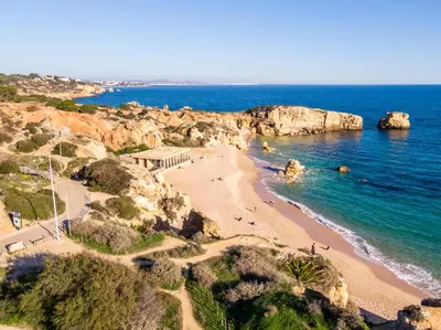 a view of a beach with people in the water at Apartment São Rafael 63 - Beach - Pool - Free wi-fi - Air Con in Albufeira