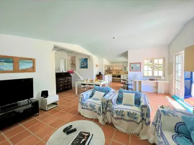 a living room with two chairs and a tv at Albufeira Balaia Villa With Private Pool by Homing in Albufeira