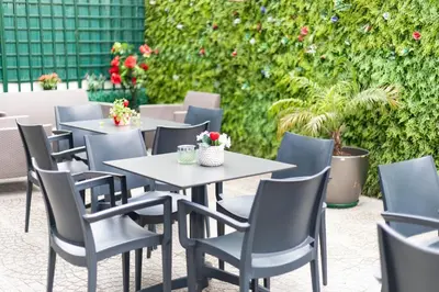 a group of tables and chairs on a patio at Avenue 41 Guest House in Faro